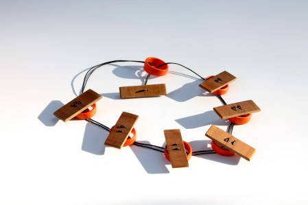 pendant, recycled plastic orange rings and wooden slates threaded together